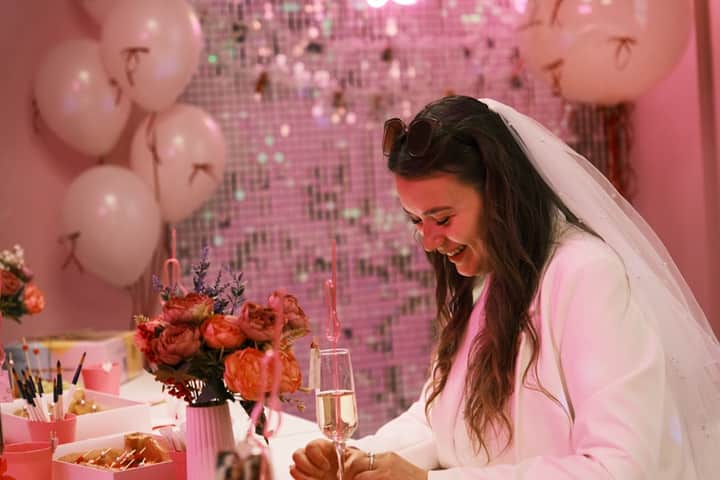 A bride raising a glass at an elegant hen party